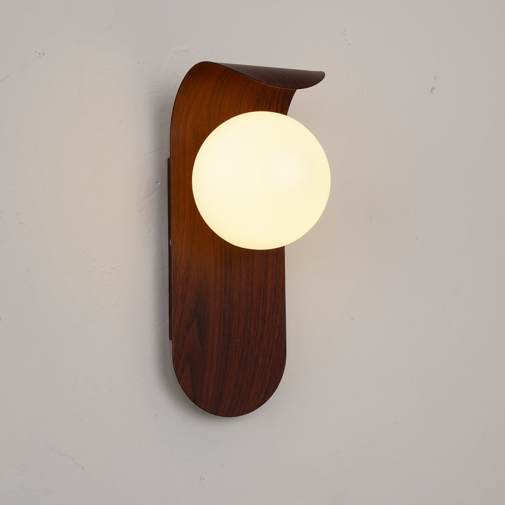 Wooden wall sconce with a round light bulb on a plain background