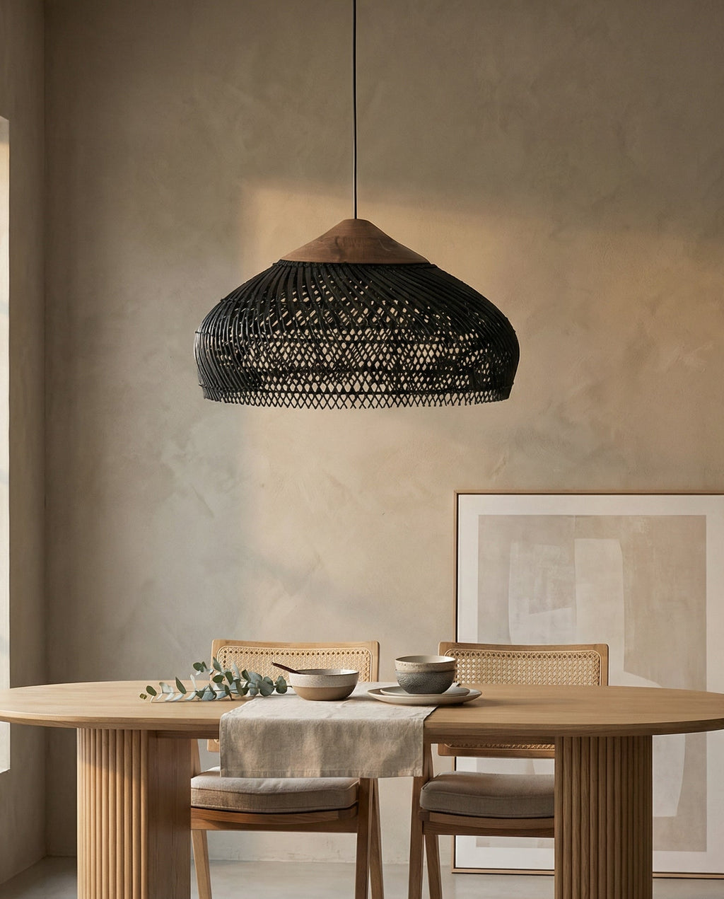 Dining room with a wooden table, chairs, and a black woven pendant light.