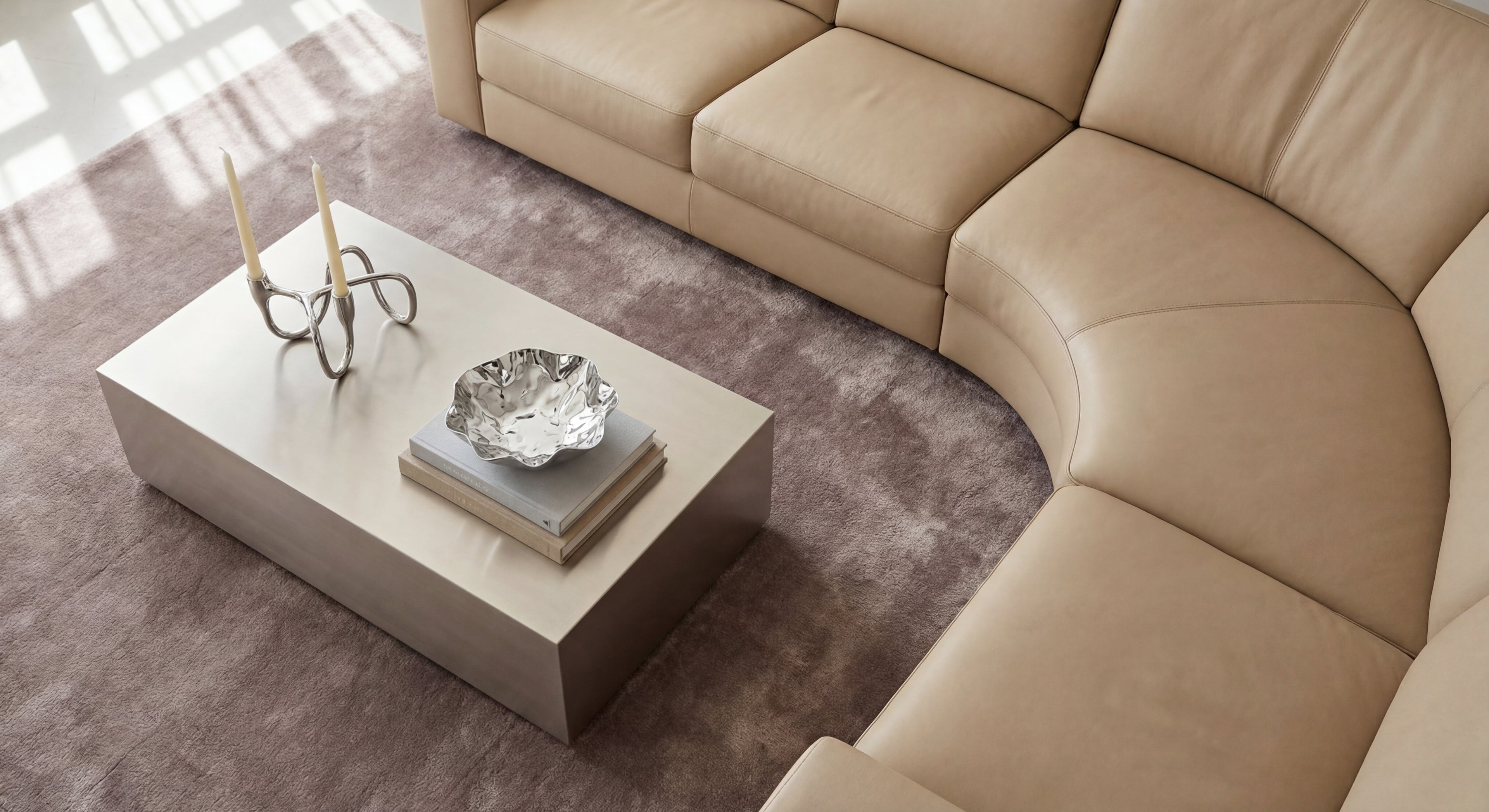Beige sectional sofa with a coffee table in a living room setting